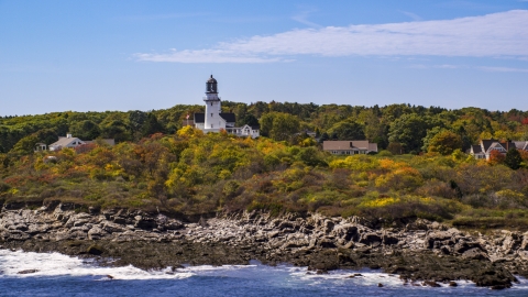 AX147_306.0000287 - Aerial stock photo of Cape Elizabeth Light seen from the rocky shore, autumn, Cape Elizabeth, Maine