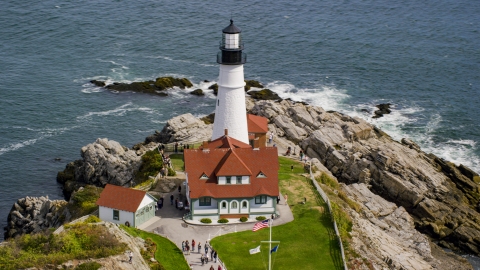 AX147_315.0000014 - Aerial stock photo of Portland Head Light by the ocean autumn, Cape Elizabeth, Maine