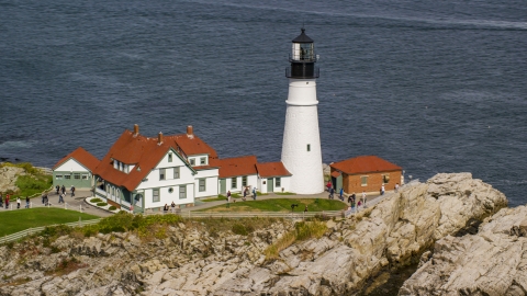 The Portland Head Light on a rocky shore overlooking the ocean in autumn, Cape Elizabeth, Maine Aerial Stock Photos | AX147_315.0000249