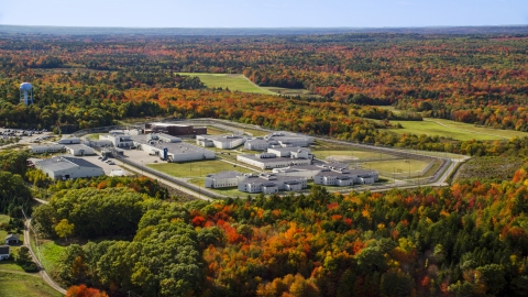 AX148_064.0000000 - Aerial stock photo of Maine State Prison by colorful forest, autumn, Warren, Maine