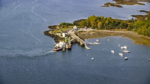 AX148_126.0000000 - Aerial stock photo of Grindel Point Light, ferry, and islands in autumn, Islesboro, Maine