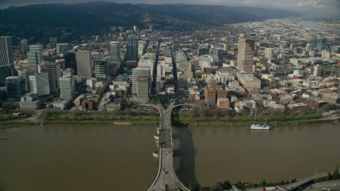 AX153_092.0000131F - Aerial stock photo of Downtown skyscrapers across the Morrison Bridge in Downtown Portland, Oregon