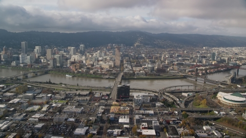 AX153_104.0000091F - Aerial stock photo of The Burnside Bridge and skyscrapers in Downtown Portland, Oregon