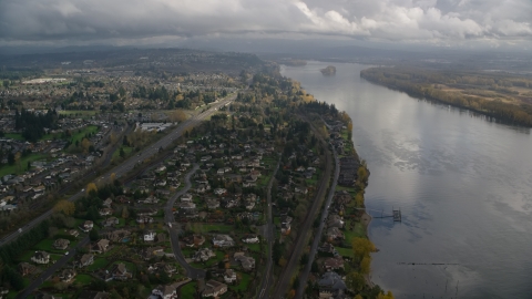 AX153_141.0000277F - Aerial stock photo of Suburban riverfront neighborhoods by Highway 14 in Vancouver, Washington