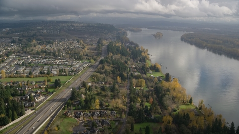 AX153_143.0000253F - Aerial stock photo of Suburban houses between Highway 14 and Columbia River, Vancouver, Washington