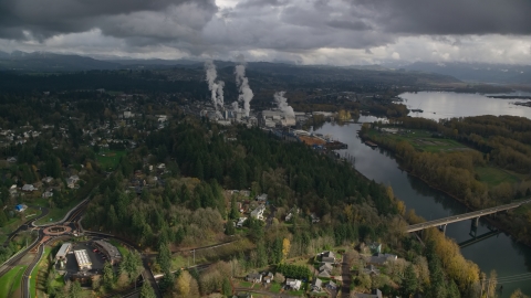 AX153_149.0000224F - Aerial stock photo of High Above Suburban Homes Looking To Paper Mill, Camas, Washington