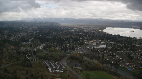 AX153_159.0000263F - Aerial stock photo of Tract homes and the Washougal River in Washougal, Washington