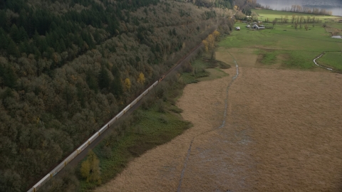 A train traveling past open farm fields in Washougal, Washington Aerial Stock Photos | AX153_179.0000000F