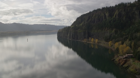 AX154_008.0000156F - Aerial stock photo of An isolated home overlooking the river in Columbia River Gorge, Washington