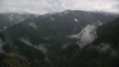 A misty canyon and a mountain ridge with light snow in Cascade Range, Hood River County, Oregon Aerial Stock Photos | AX154_052.0000243F