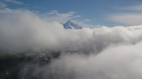 Mount Hood, visible above a layer of thick clouds, Cascade Range, Oregon Aerial Stock Photos | AX154_060.0000000F