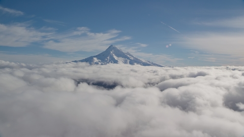 AX154_065.0000000F - Aerial stock photo of Snowy summit of Mount Hood above the clouds, Cascade Range, Oregon