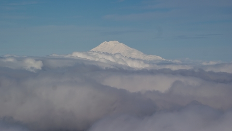 AX154_069.0000000F - Aerial stock photo of Mt Adams' snowy summit in the distance and low cloud cover, Cascade Range, Oregon