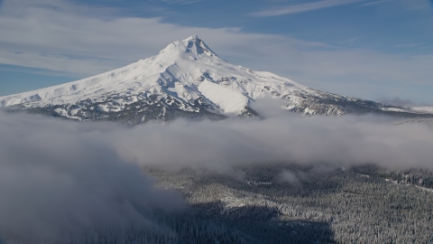 AX154_117.0000237F - Aerial stock photo of Snow-capped mountain peak and low clouds, Mount Hood, Cascade Range, Oregon