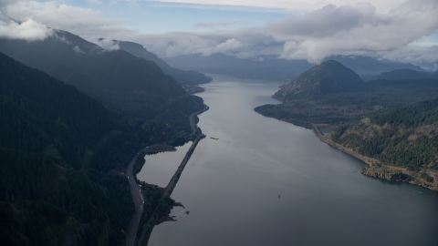 AX154_156.0000000F - Aerial stock photo of The I-84 highway at the base of mountains in Columbia River Gorge