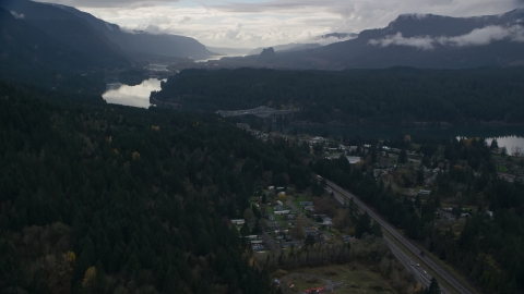 AX154_170.0000035F - Aerial stock photo of Evergreens by Interstate 84 in the town of Cascade Locks, Oregon in Columbia River Gorge