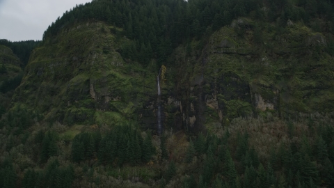 A waterfall on steep green cliffs on the Oregon side of Columbia River Gorge Aerial Stock Photos | AX154_187.0000134F