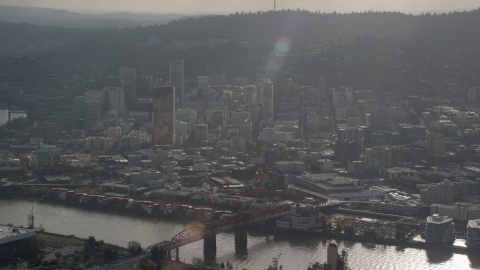AX154_226.0000265F - Aerial stock photo of Godrays shining down on the Willamette River and Downtown Portland, Oregon