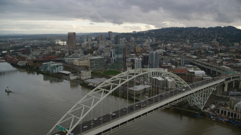 AX155_035.0000270F - Aerial stock photo of Fremont Bridge near skyscrapers in Downtown Portland, Oregon