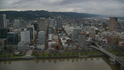 AX155_051.0000183F - Aerial stock photo of Skyscrapers, downtown buildings, and city park near the river in Downtown Portland, Oregon