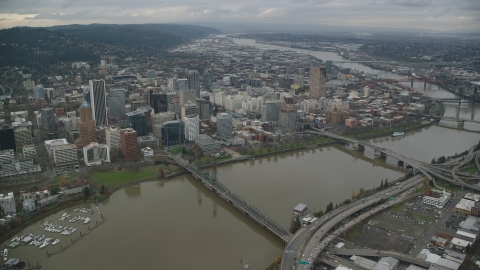 AX155_094.0000333F - Aerial stock photo of Downtown Portland cityscape and waterfront park seen from the bridges over the Willamette River in Oregon