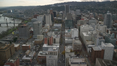 AX155_113.0000181F - Aerial stock photo of Top of US Bancorp Tower, and city streets and skyscrapers in Downtown Portland, Oregon