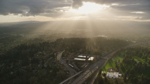 AX155_119.0000000F - Aerial stock photo of Godrays shining down on suburban neighborhoods and Highway 26, Southwest Portland, Oregon