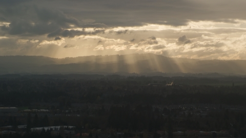 Distant mountains and godrays from the clouds near Beaverton, Oregon, at sunset Aerial Stock Photos | AX155_125.0000111F