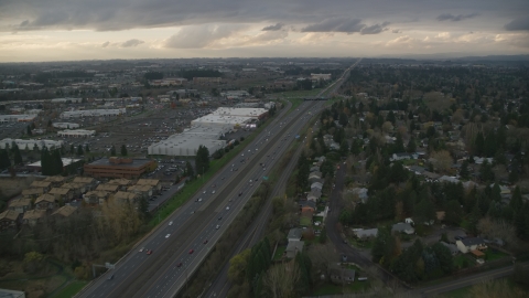 AX155_127.0000321F - Aerial stock photo of Apartment buildings along Highway 26 by Tanasbourne Town Center in Hillsboro, Oregon, sunset