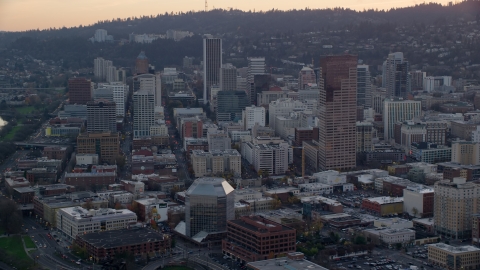 AX155_156.0000192F - Aerial stock photo of Skyscrapers and high-rises in Downtown Portland, Oregon, sunset