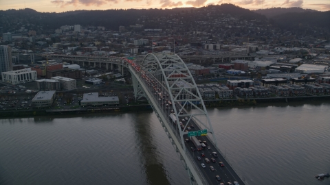 Heavy traffic crossing the Fremont Bridge at sunset in Downtown Portland, Oregon Aerial Stock Photos | AX155_158.0000229F