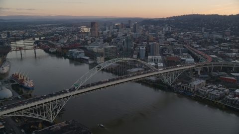 AX155_161.0000000F - Aerial stock photo of Heavy traffic on the Fremont Bridge at sunset, Downtown Portland in the background, Oregon