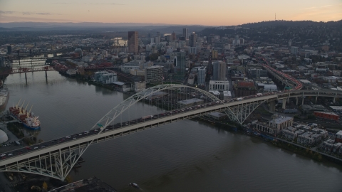 AX155_161.0000096F - Aerial stock photo of Heavy traffic on the Fremont Bridge at sunset, Downtown Portland in the background, Oregon