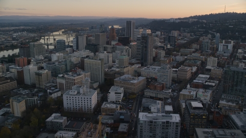 AX155_164.0000248F - Aerial stock photo of NW 10th Avenue through Downtown Portland, Oregon, at sunset to Park Avenue West Tower