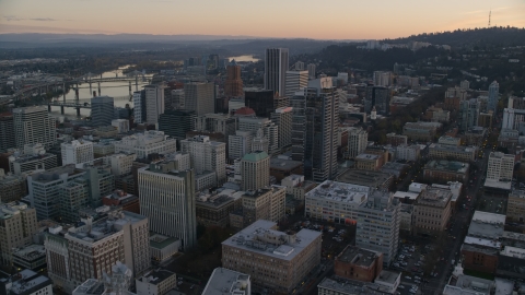 AX155_164.0000342F - Aerial stock photo of NW 10th Avenue through Downtown Portland, Oregon, at sunset to Park Avenue West Tower