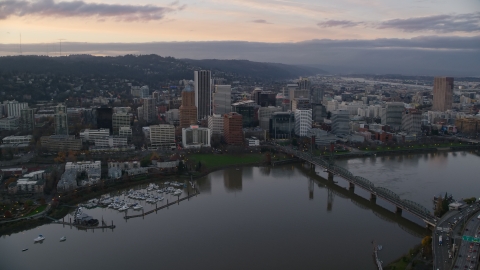 AX155_172.0000300F - Aerial stock photo of Bridge spanning the Willamette River near Downtown Portland at sunset, Oregon