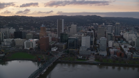 AX155_173.0000275F - Aerial stock photo of Hawthorne Bridge, waterfront park, and Downtown Portland at sunset in Oregon