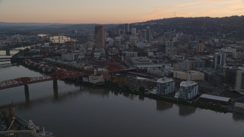 AX155_184.0000216F - Aerial stock photo of Downtown Portland skyscrapers and Union Station seen from near the Broadway Bridge at sunset in Oregon