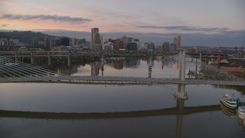 AX155_200.0000031F - Aerial stock photo of Tilikum Crossing, Marquam Bridge and downtown skyline at sunset, Downtown Portland, Oregon