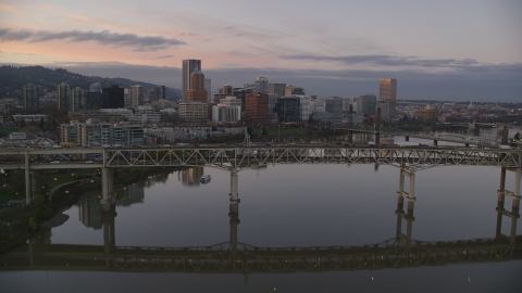 AX155_200.0000319F - Aerial stock photo of Tilikum Crossing, Marquam Bridge and downtown skyline at sunset, Downtown Portland, Oregon