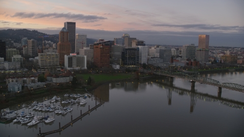 AX155_201.0000355F - Aerial stock photo of Marquam Bridge, marina, Hawthorne Bridge, and downtown skyline at sunset, Downtown Portland, Oregon