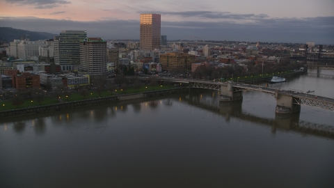 AX155_203.0000000F - Aerial stock photo of Morrison Bridge, waterfront park and downtown skyline at sunset, Downtown Portland, Oregon