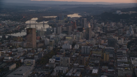 AX155_219.0000000F - Aerial stock photo of Downtown Portland cityscape by the Willamette River at sunset, Oregon