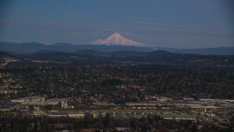 AX155_248.0000000F - Aerial stock photo of Mount Hood at sunset, seen from a train yard and neighborhoods in Southeast Portland, Oregon