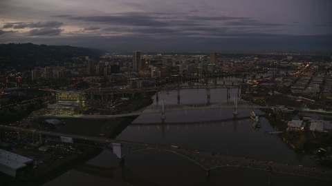 AX155_249.0000000F - Aerial stock photo of Downtown skyscrapers and bridges over the Willamette River at sunset, Downtown Portland, Oregon