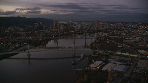 AX155_249.0000272F - Aerial stock photo of Skyscrapers and bridges over the Willamette River at sunset, Downtown Portland, Oregon