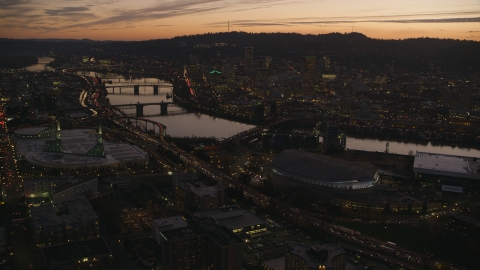 Moda Center, Willamette River, and downtown skyscrapers at sunset, Downtown Portland, Oregon Aerial Stock Photos | AX155_260.0000149F