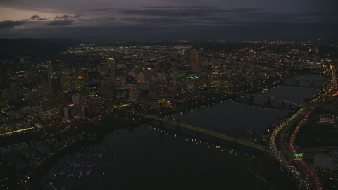 AX155_268.0000248F - Aerial stock photo of Downtown Portland's cityscape beside the Willamette River at sunset, Oregon