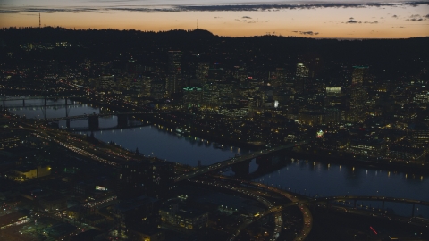 AX155_298.0000000F - Aerial stock photo of Downtown skyscrapers, Willamette River bridges, and freeway interchange at night, Downtown Portland, Oregon