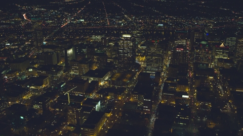 AX155_401.0000260F - Aerial stock photo of High-rises, skyscrapers, and busy streets at nighttime in Downtown Portland, Oregon